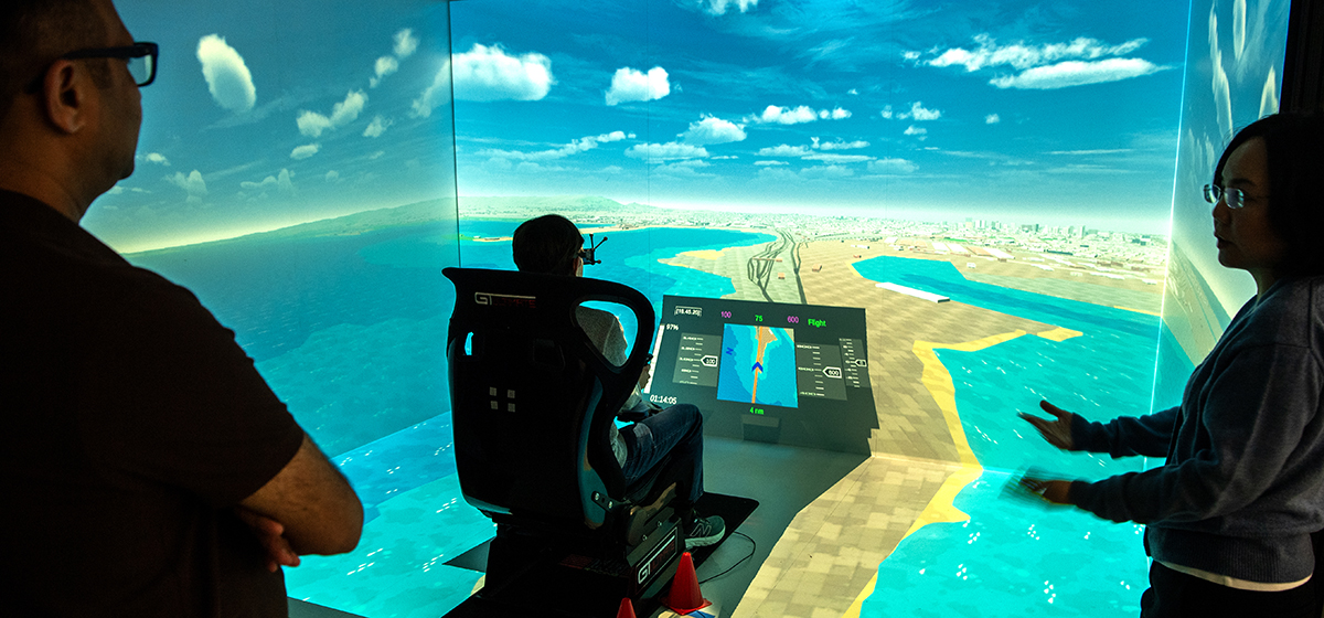 A pilot running a UAM drone simulation inside the CAVE VR system at San Jose State University